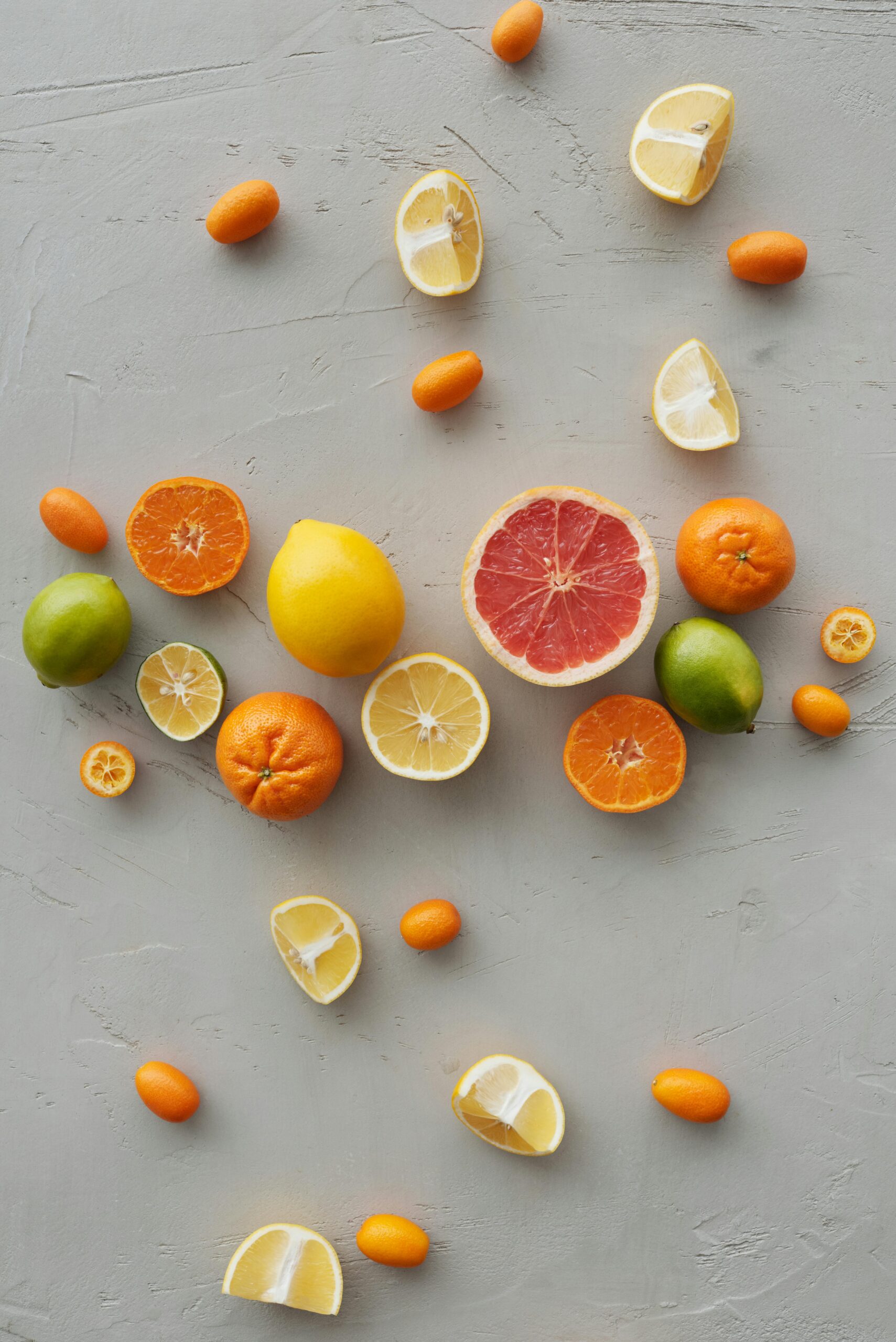 Flat lay of assorted citrus fruits slices, including lemon, lime, and grapefruit.